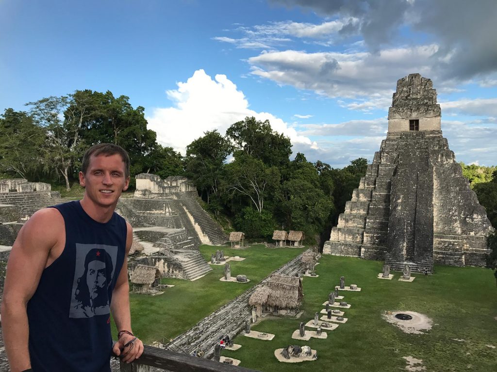 David Simpson with Mayan ruins in Tikal, Guatemala. A dislocated shoulder & Tikal Ruins