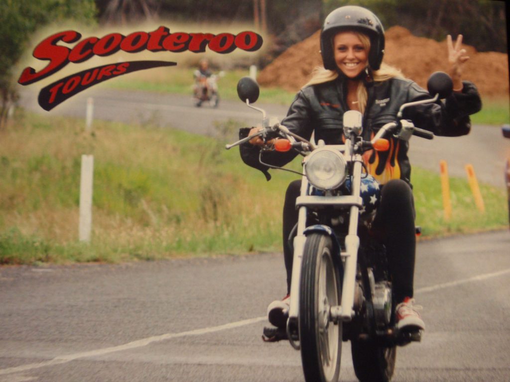A girl riding a motor bike in Scooter Roo tour in Fraser Island. Dingos on Fraser Island