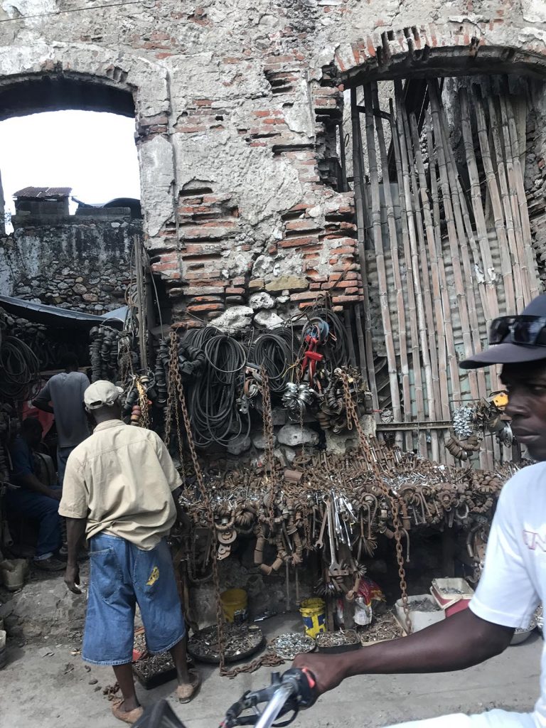 Junk store near ruined building in Haiti. Haiti & Dominican Republic, an Island of two halves