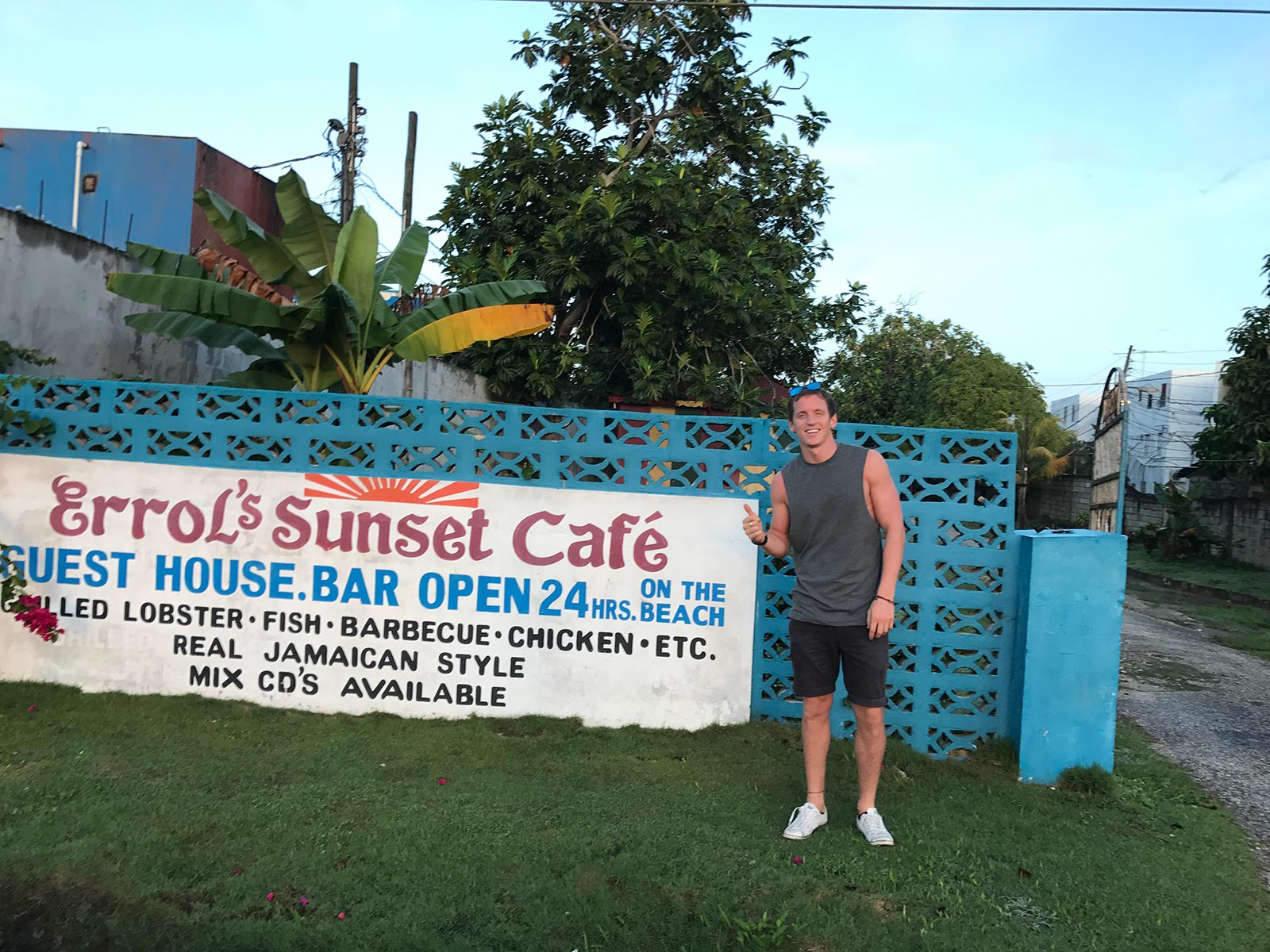 David Simpson standing near signage in Negril, Jamaica. Getting chased in Jamaica