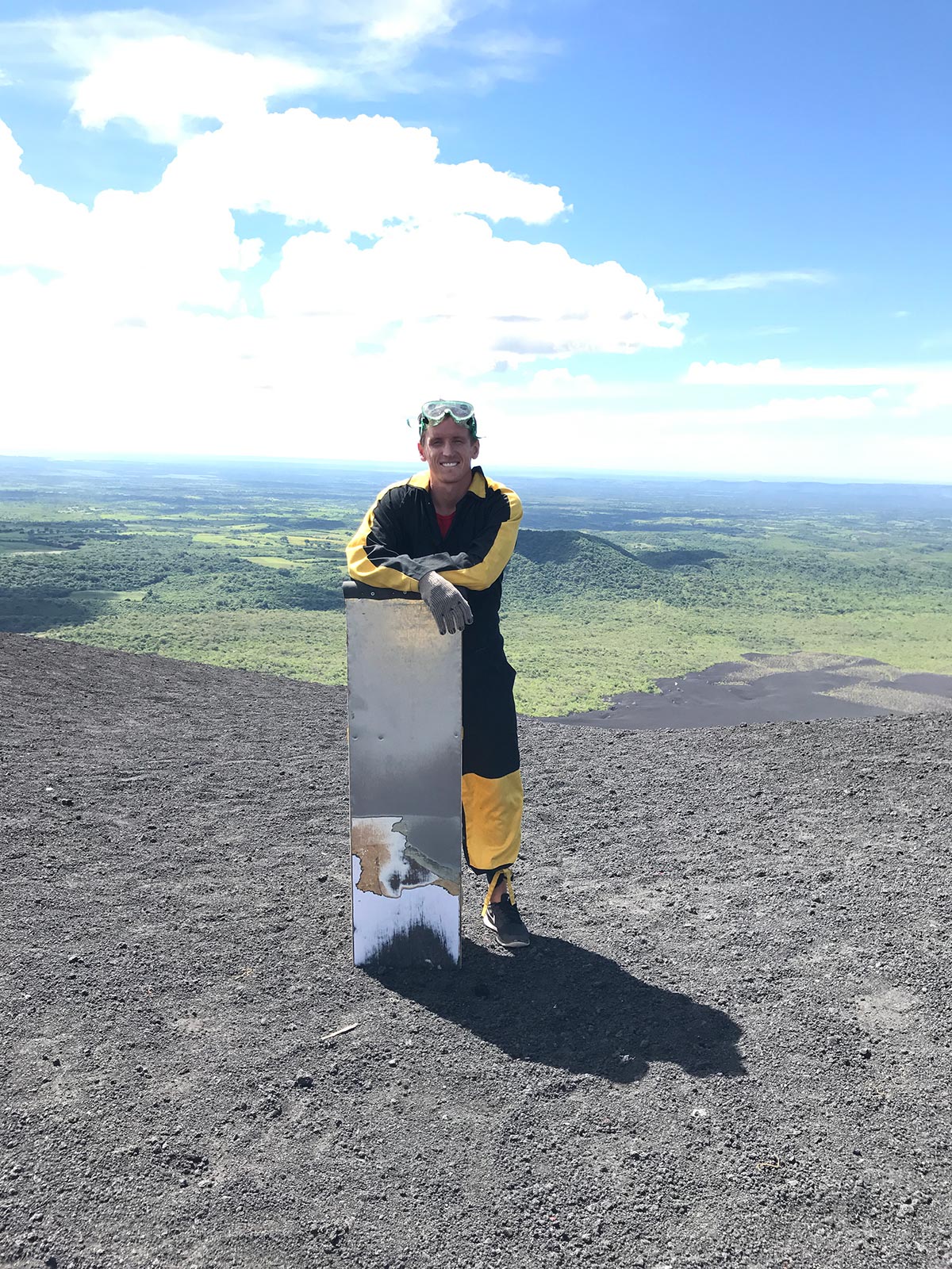 David Simpson with board on top of the volcano in Leon, Nicaragua. Volcano boarding in Leon, Nicaragua & full guide