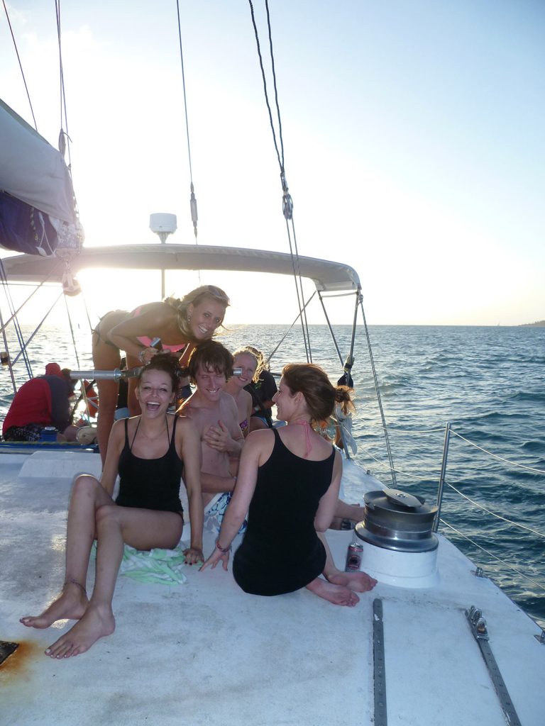David Simpson with four girls on the side of the boat during the Whitsundays cruise. Sleeping under the stars at the Whitsundays