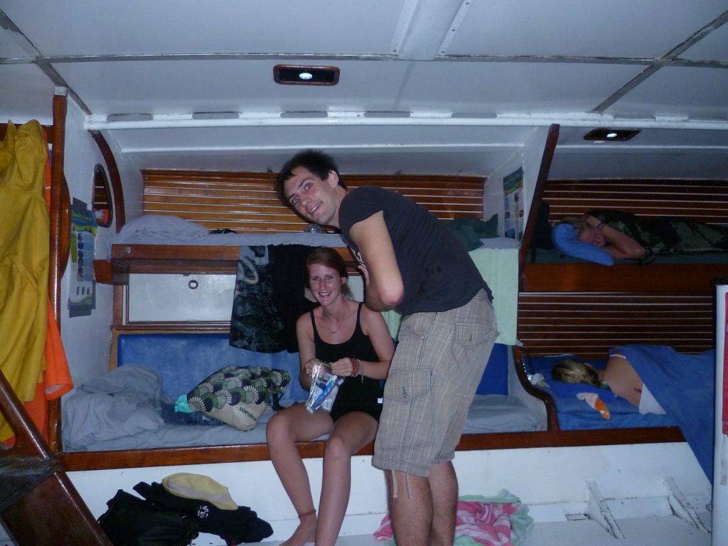 A guy and a girl getting comfortable during the Whitsundays cruise. Sleeping under the stars at the Whitsundays