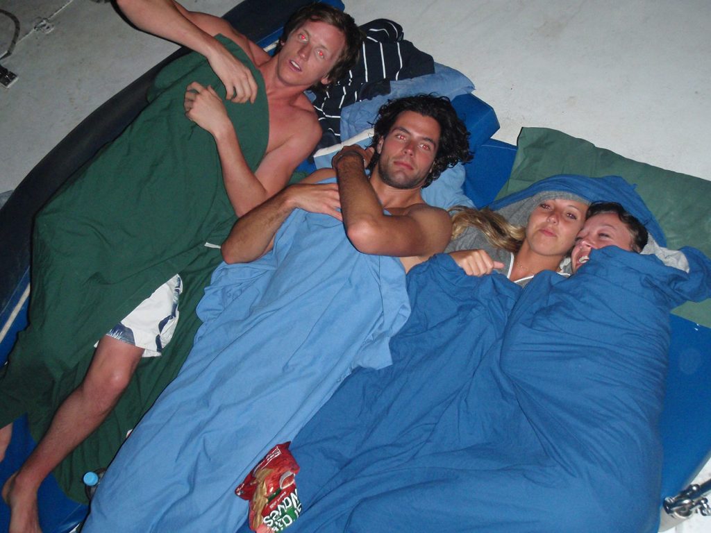 David Simpson with a guy and two girls getting ready to sleep during the Whitsundays cruise. Sleeping under the stars at the Whitsundays