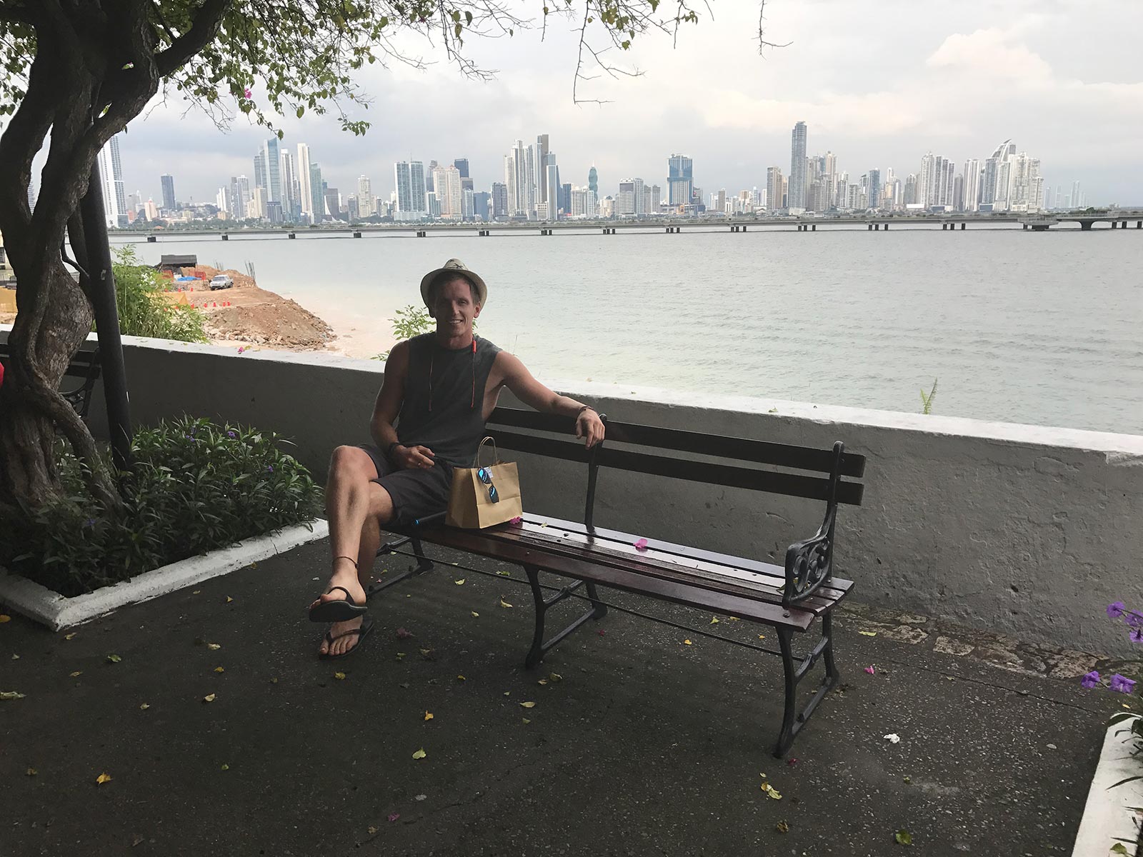 David Simpson sitting on a bench by the bay in Panama City, Panama. Panama Canal & the last of Central America