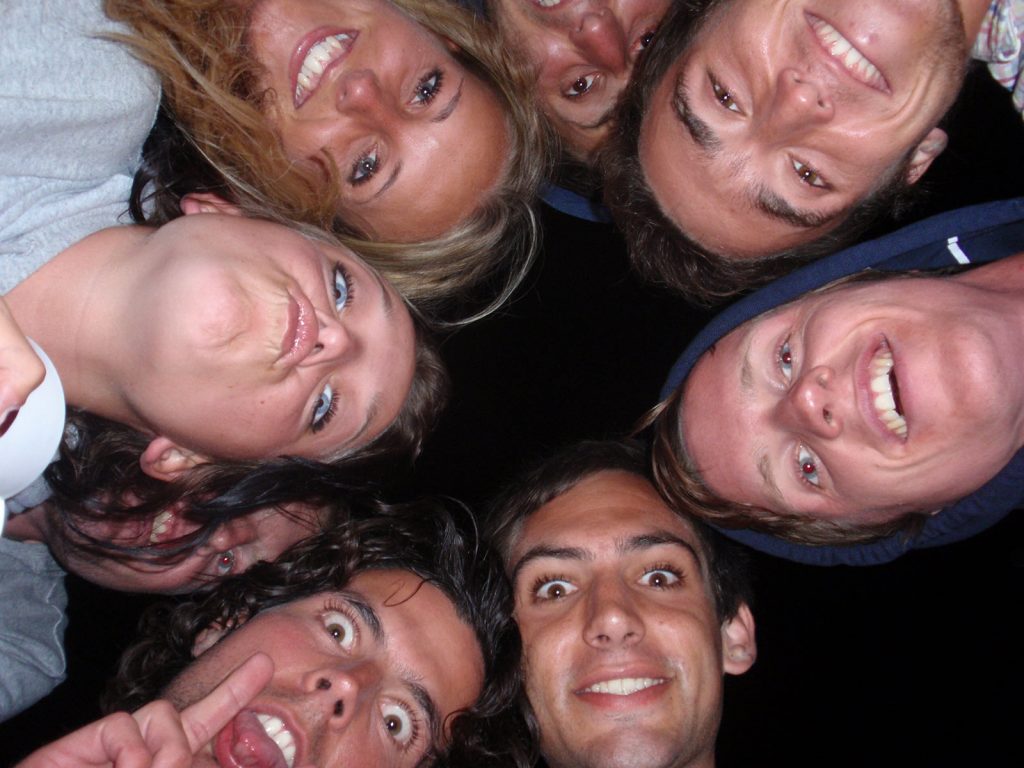 Group of people looking down on the camera during the Whitsundays cruise. Sleeping under the stars at the Whitsundays