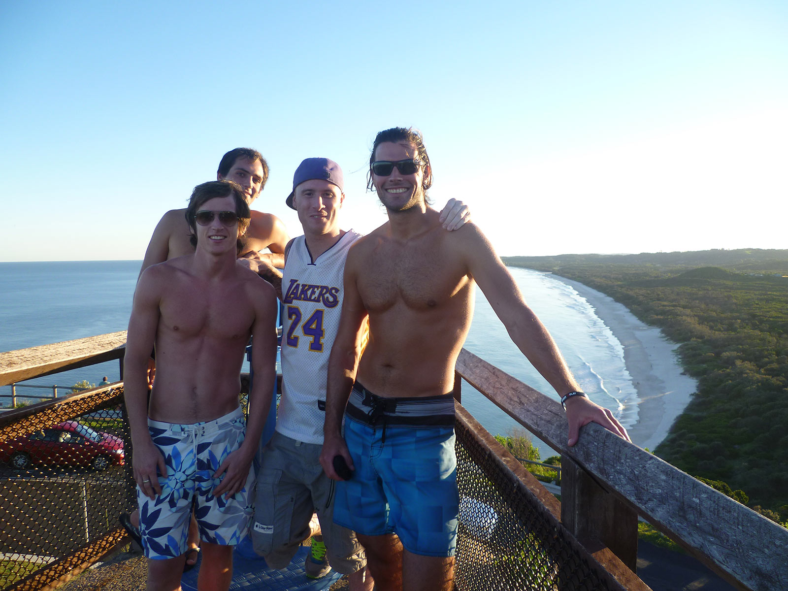 David Simpson with three guys during sunset at the lighthouse at Byron Bay Beach. The Zoo, Brissie & Byron Bay