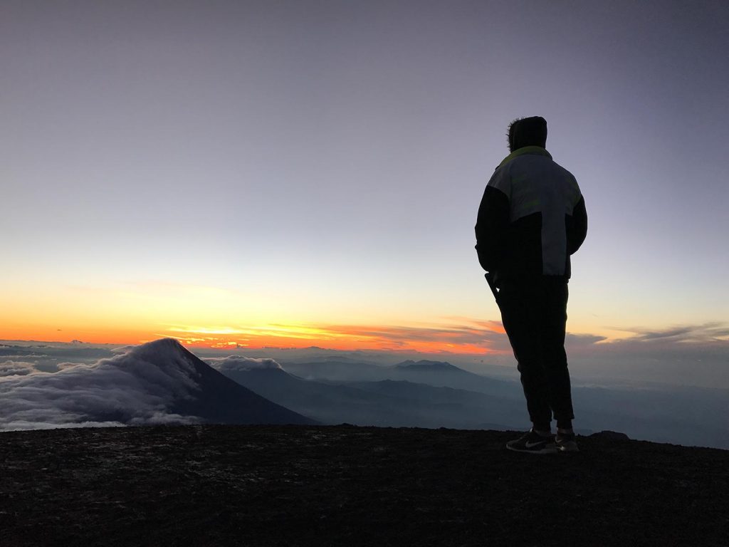 David Simpson viewing sunrise in Antigua, Guatemala. Volcano hiking in Guatemala