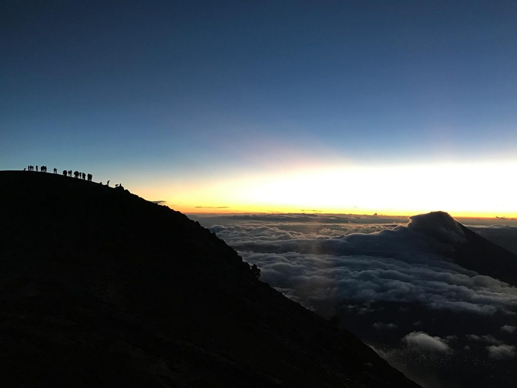 Sunrise above the clouds in Antigua, Guatemala. Volcano hiking in Guatemala