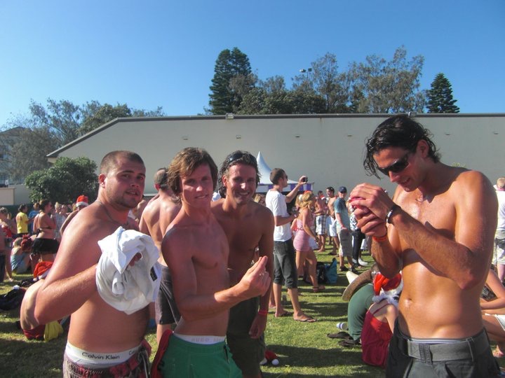David Simpson with three guys spending Xmas on Bondi at Sunburnt festival. Xmas & NYE in Bondi, Sydney