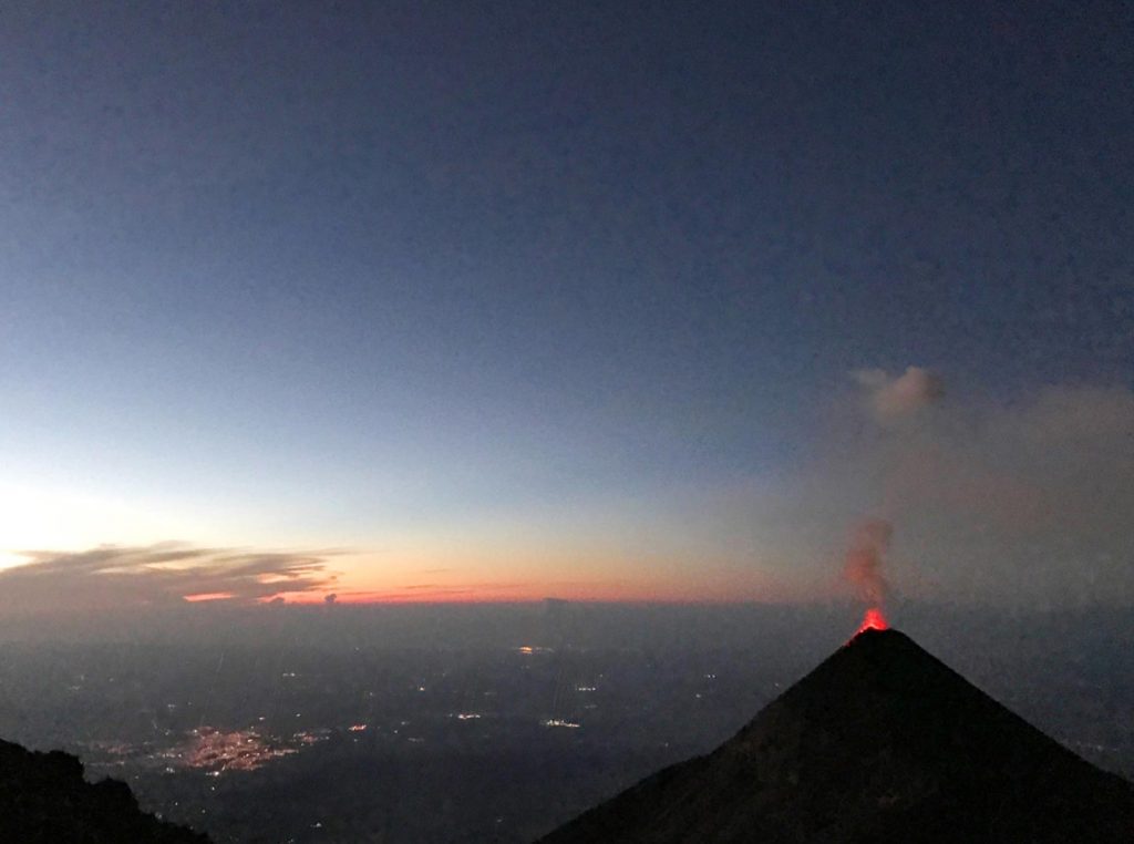 Sunrise and an active volcano in Antigua, Guatemala. Volcano hiking in Guatemala