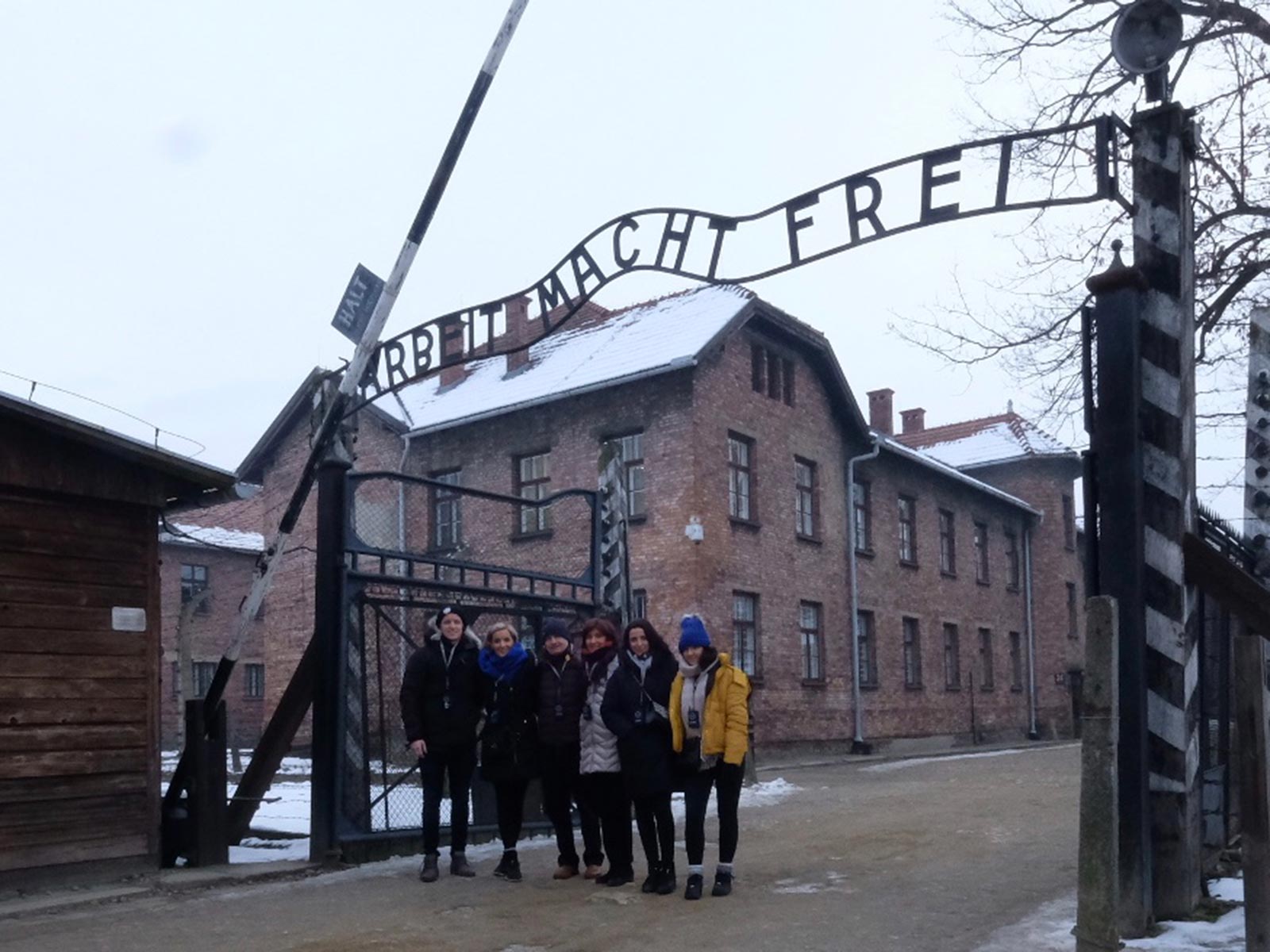 David Simpson and family at the gate in Auschwitz, Oświęcim, Poland. Mixed feelings in Auschwitz