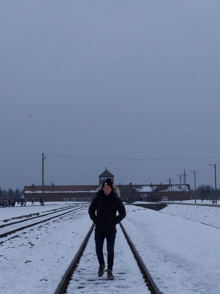 David Simpson on railroad tracks in Auschwitz, Oświęcim, Poland. Mixed feelings in Auschwitz