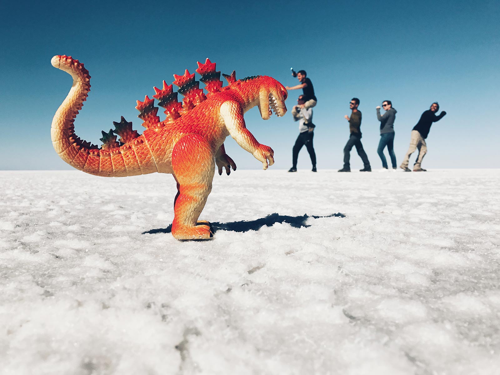 David Simpson and friends fighting Godzilla in Uyuni Salt Flat, Bolivia. Atacama desert & Bolivian salt flats road trip & full guide