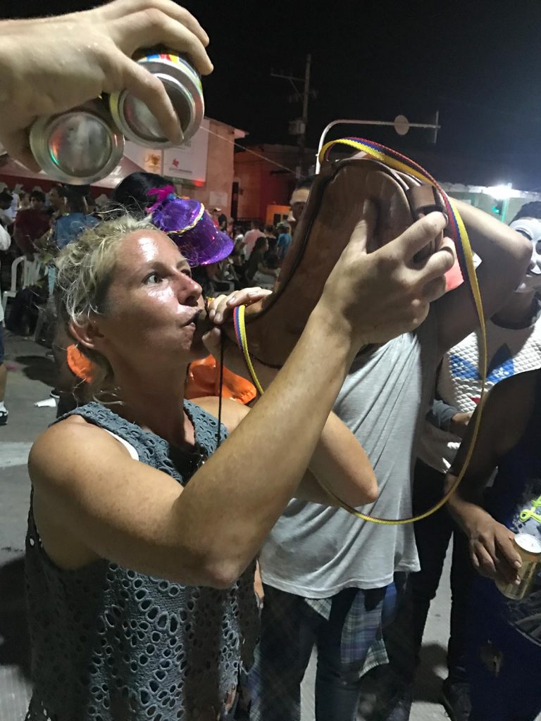 Friend girl drinking at carnival in Barranquilla, Colombia. 4 weeks and Carnival in Colombia