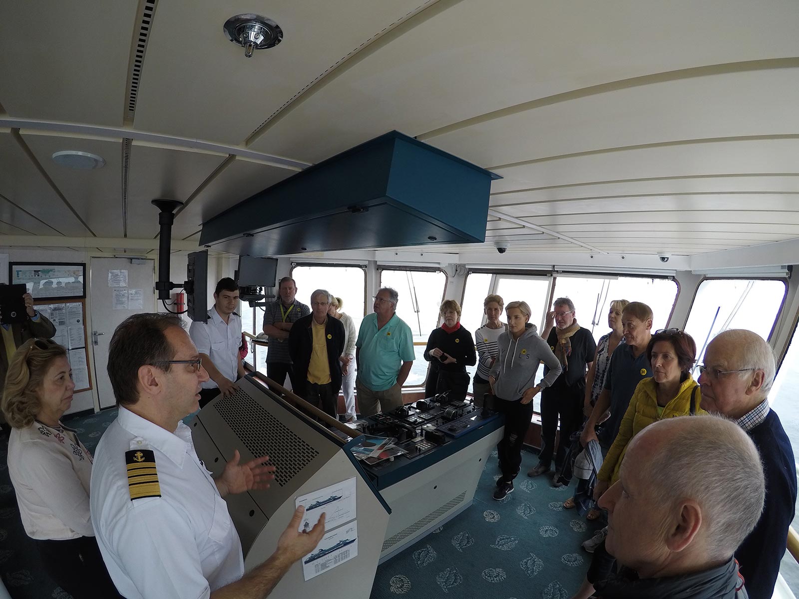 The captain talking to the passengers on a tour at the ship's bridge while passing Chilean fjord. Valparaiso & The Cruise to the end of the World pt3