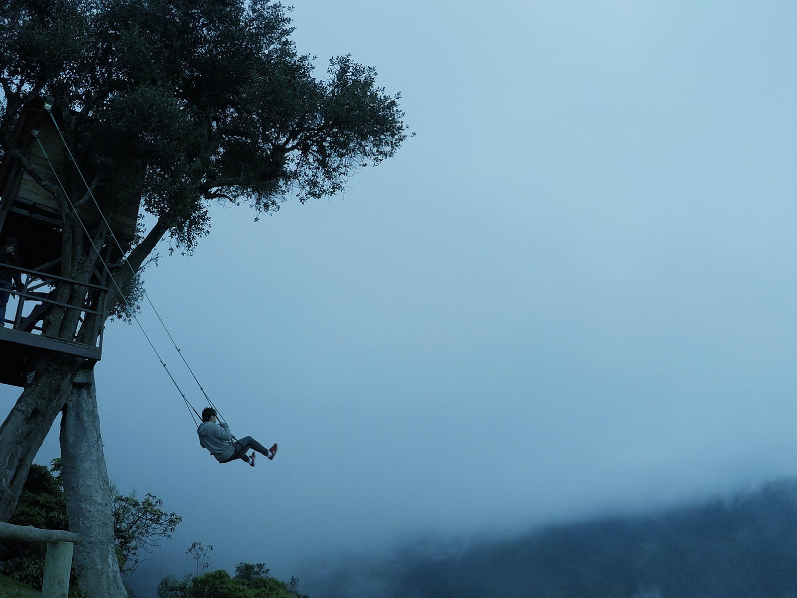 The swing at the end of the world during a cloudy day in Banôs, Ecuador. A Swing, The Equator & needing the Banôs in Banôs