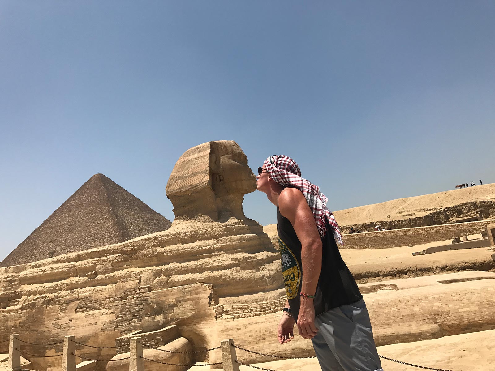 David Simpson kissing the Sphinx near a pyramid in Cairo, Egypt. Getting inside the Ancient Pyramids of Giza