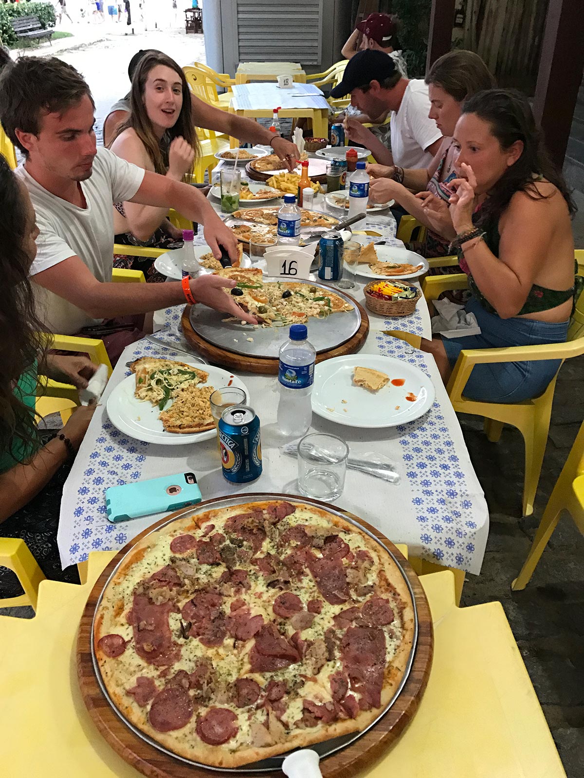 Friends having pizza in Ilha Grande, Brazil. Ilha Grande cures the hangover from hell