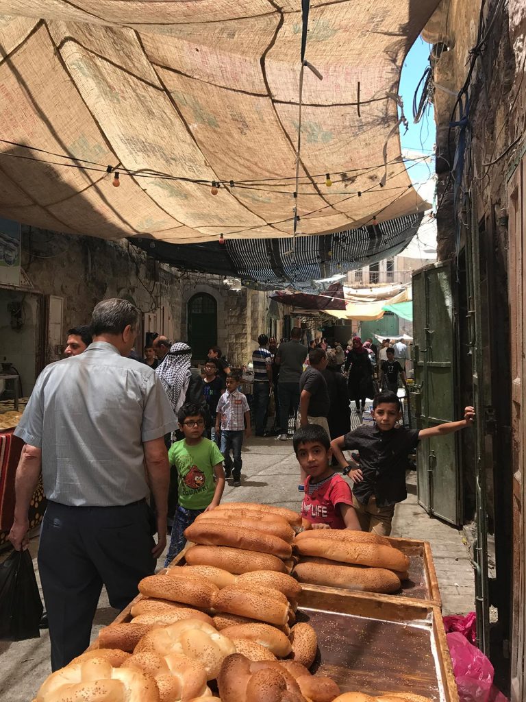 Kids, people and bread for sale at Palestine in Jerusalem, Israel. My time in Jerusalem, a special city divided