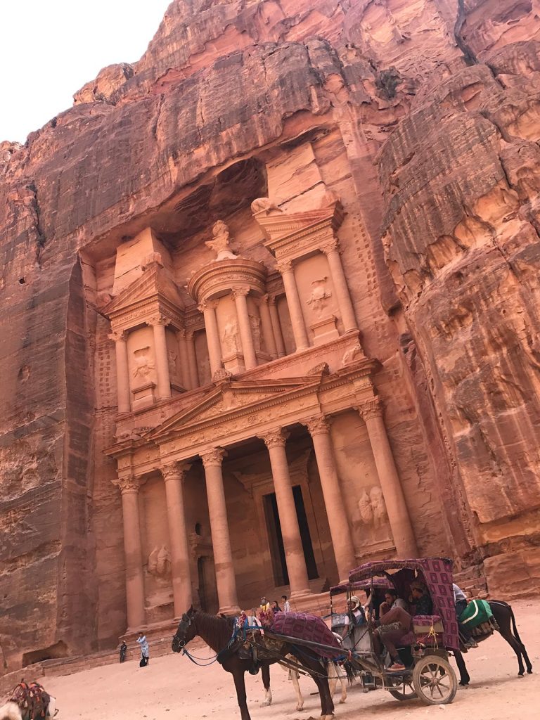 Horse drawn carriages and the Treasury in Petra, Jordan. Petra, an incredible wonder