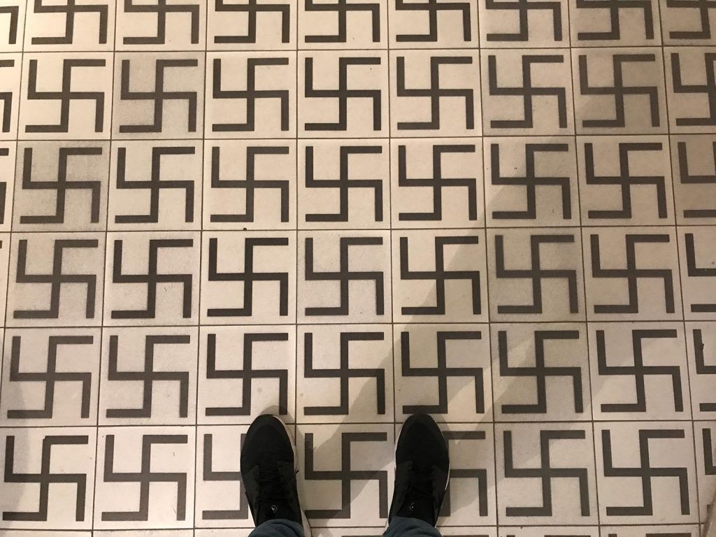 Swastika symbols on the floor being walked over at Jewish Quarter in Kazimierz, Krakow, Poland. Mixed feelings in Auschwitz 