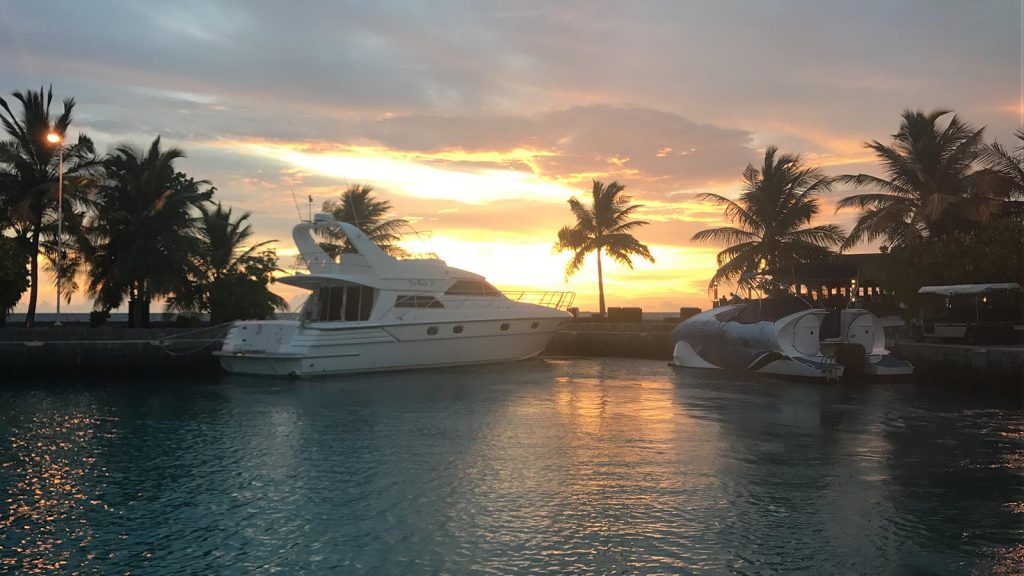 Docked boats at sunset in Maldives. The Maldives & upgraded to the best villa on the island