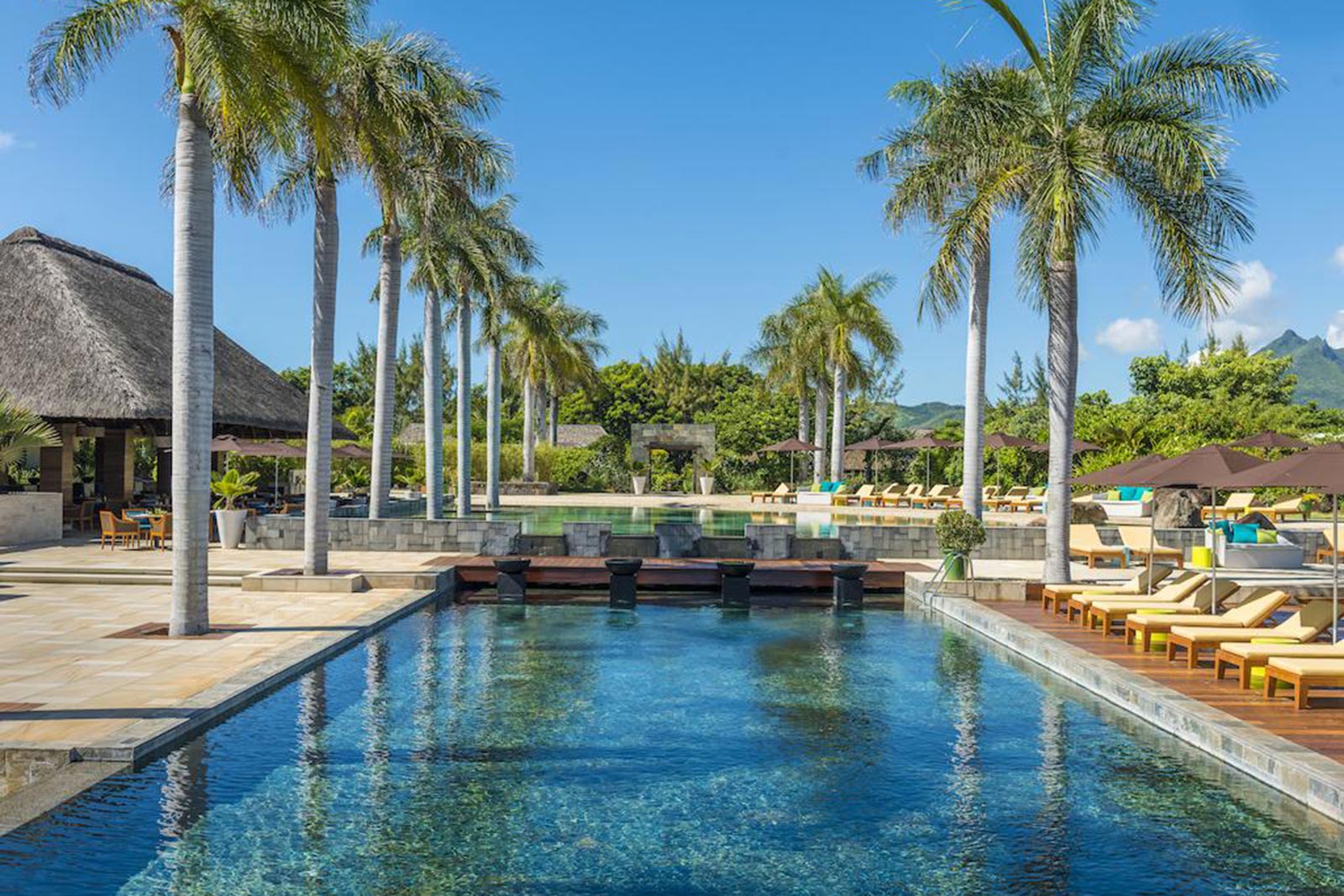 Pool with coconut trees in a resort in Mauritius. Where to stay in Mauritius, the best resort in Mauritius