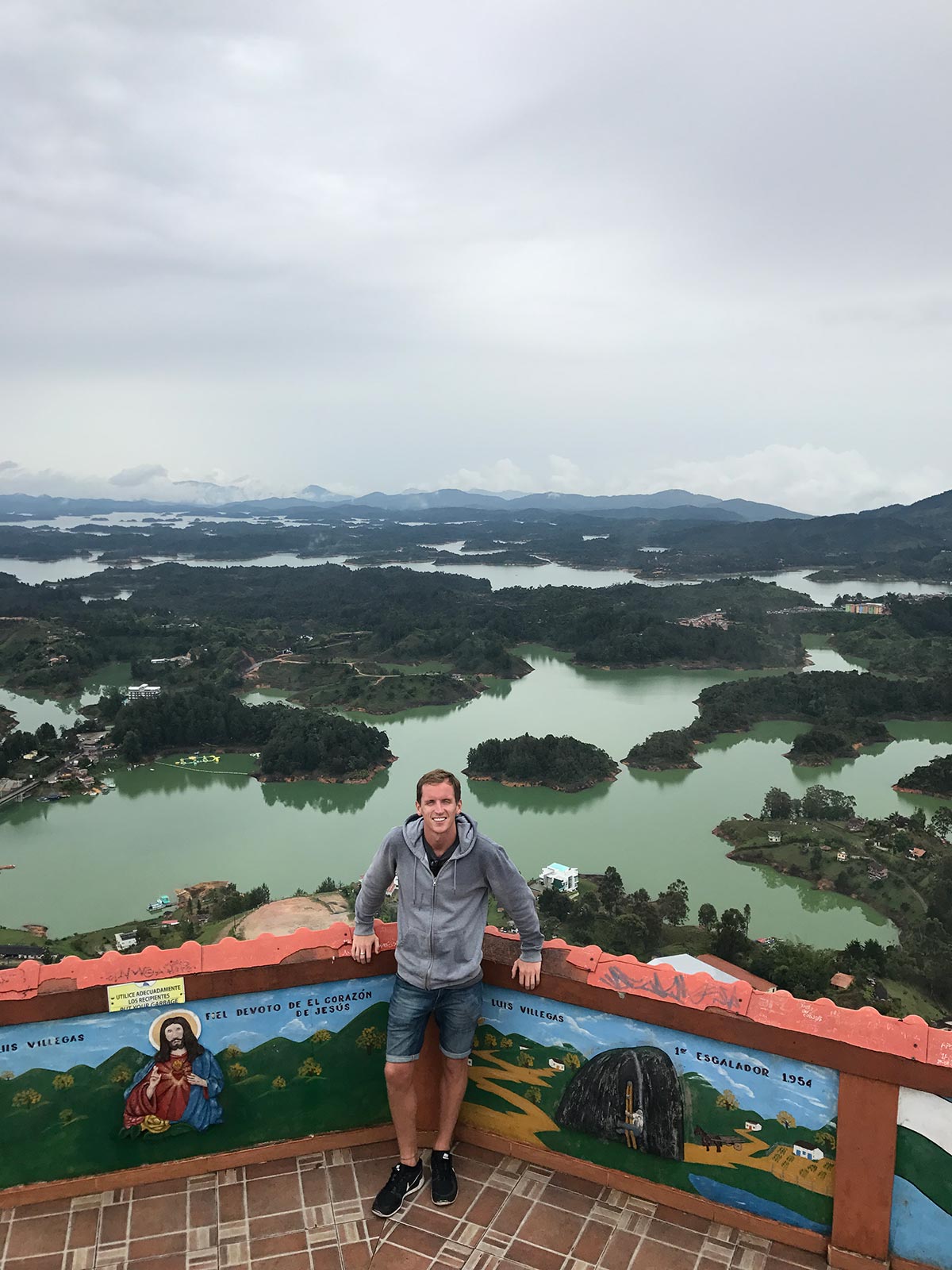 David Simpson on top of the giant rock, Piedra del Peñol at the Peñol-Guatapé Reservoir reservoir in Medellin, Colombia. 4 weeks and Carnival in Colombia