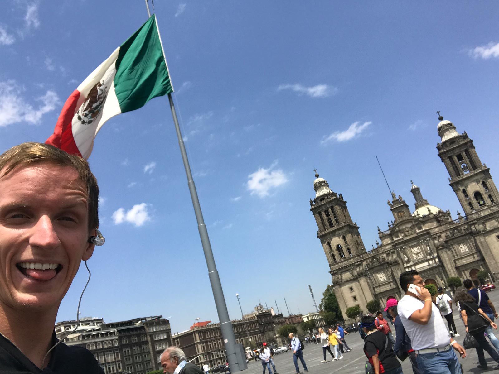 David Simpson with Mexican flag and cathedral in Tenochtitlanin, Mexico. Mexico City & Teotihuacan