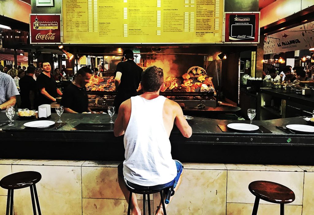 David Simpson seated at a food counter in Montevideo, Uruguay. Iguazu Falls & the cruise to the end of the World pt1