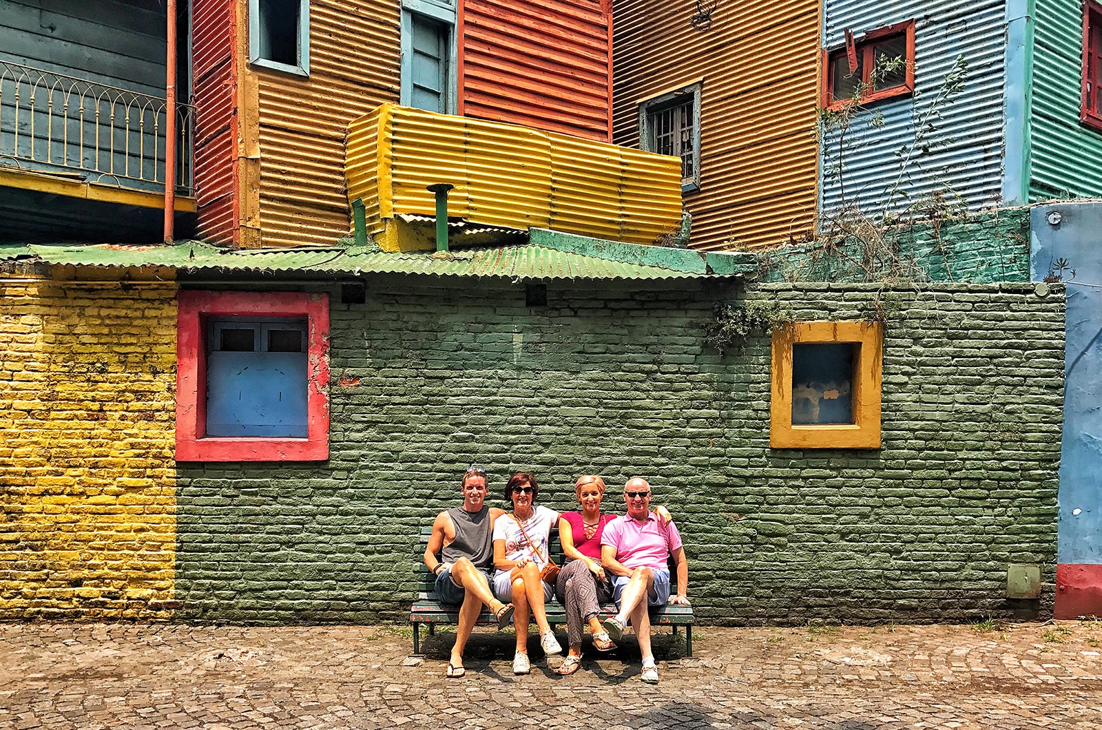 David Simpson and family sitting by big colorful house in Buenos Aires, Argentina. NYE in Buenos Aires
