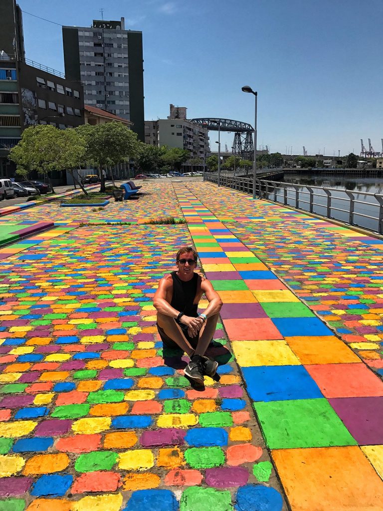 David Simpson sitting on the colorful sidewalk in Buenos Aires, Argentina. NYE in Buenos Aires