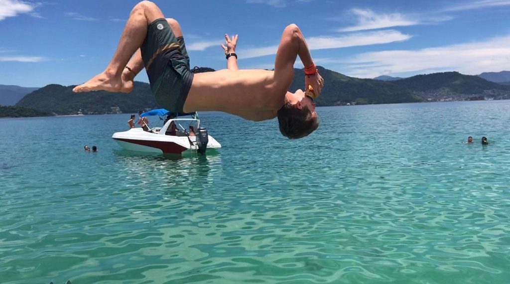 David Simpson diving into the water from the party boat in Paraty, Brazil. Rockfalls, Paraty boat party and nearly losing my head