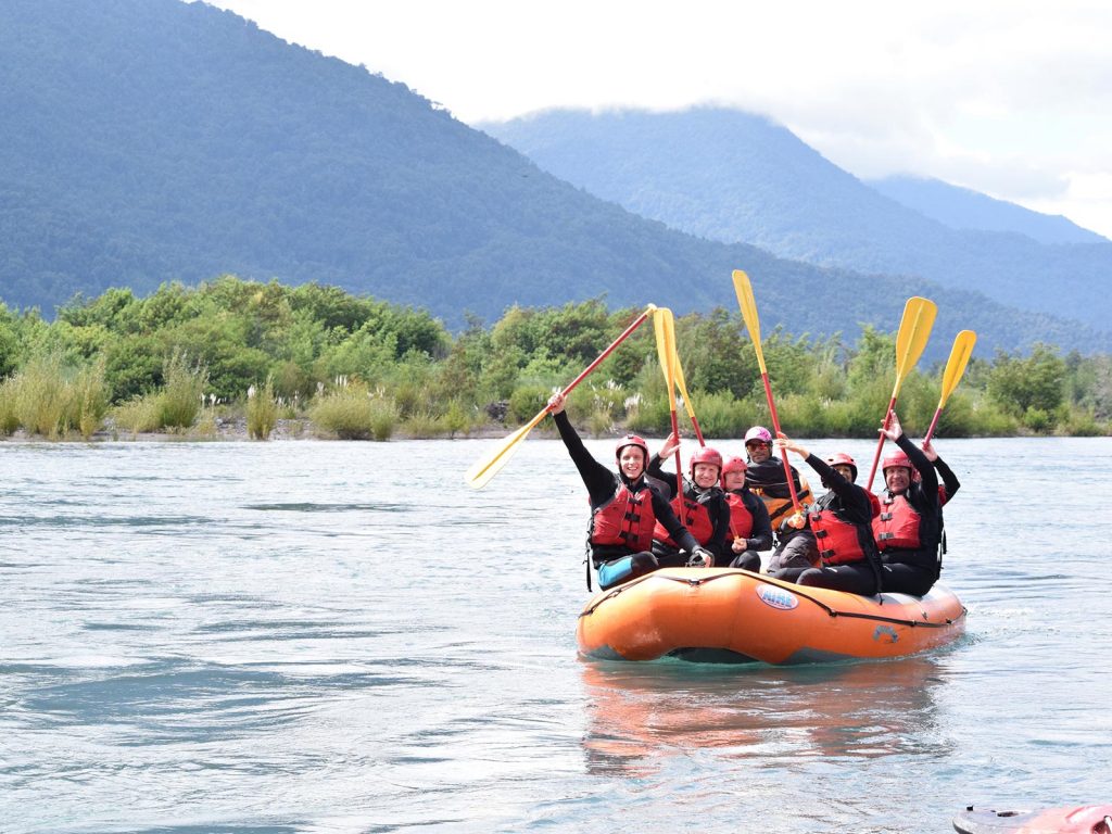 David Simpson and fellow rafters raising their oars on White Water rafting at Puerto Montt, Chile. Valparaiso & The Cruise to the end of the World pt3