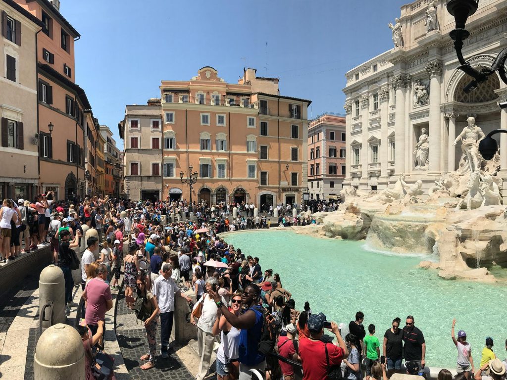 Large crowd around Trevi Fountain in Rome, Italy. The Colosseum & Rome, the last wonder