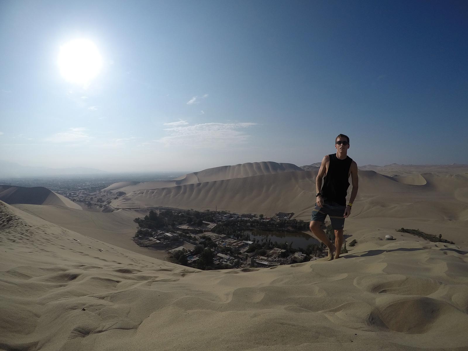 David Simpson standing on sand dune in Huacachina, Peru. Sand boarding in Huacachina & full guide