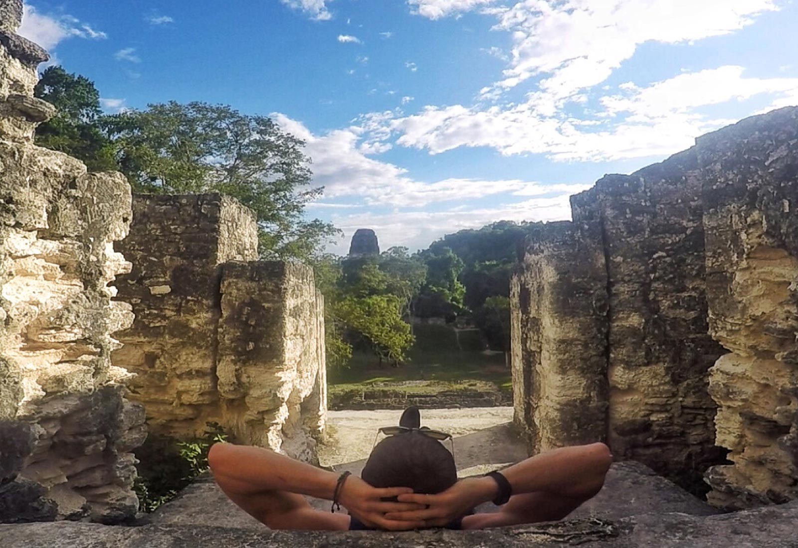 David Simpson amid Mayan ruins in Tikal, Guatemala. A dislocated shoulder & Tikal Ruins