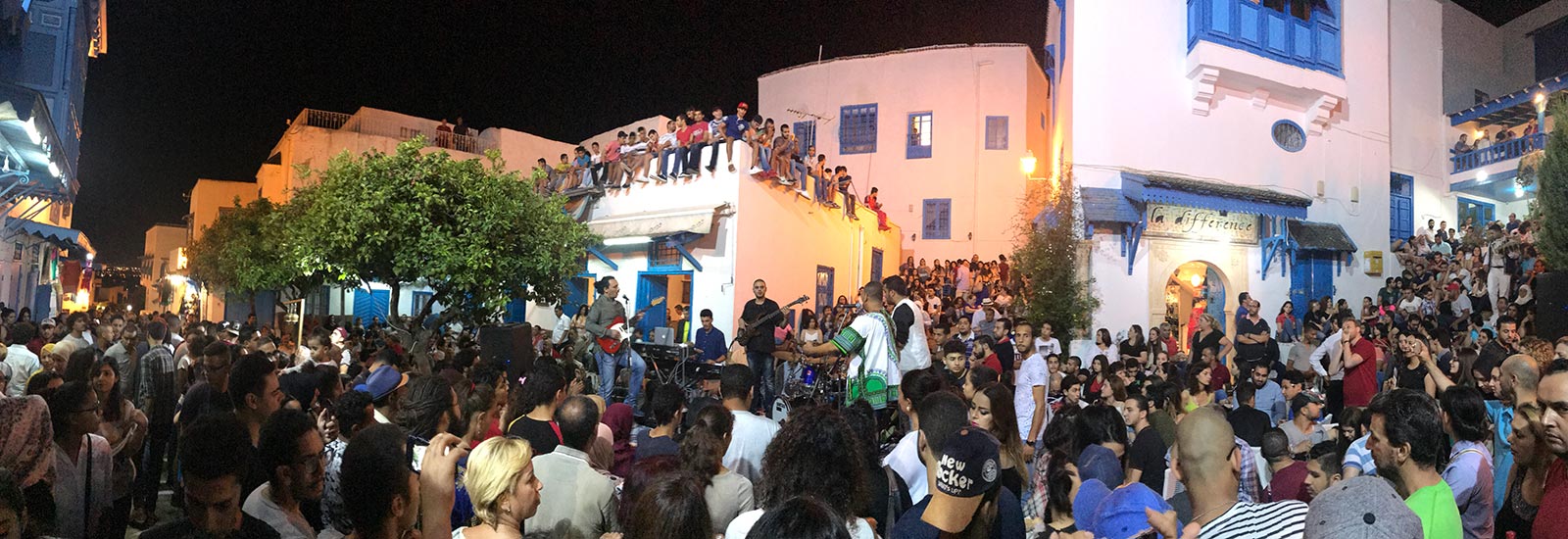 Crowd of people at the street party at night in Sidi Bou Said, Tunisia. Tunisia and not taking travel advice seriously