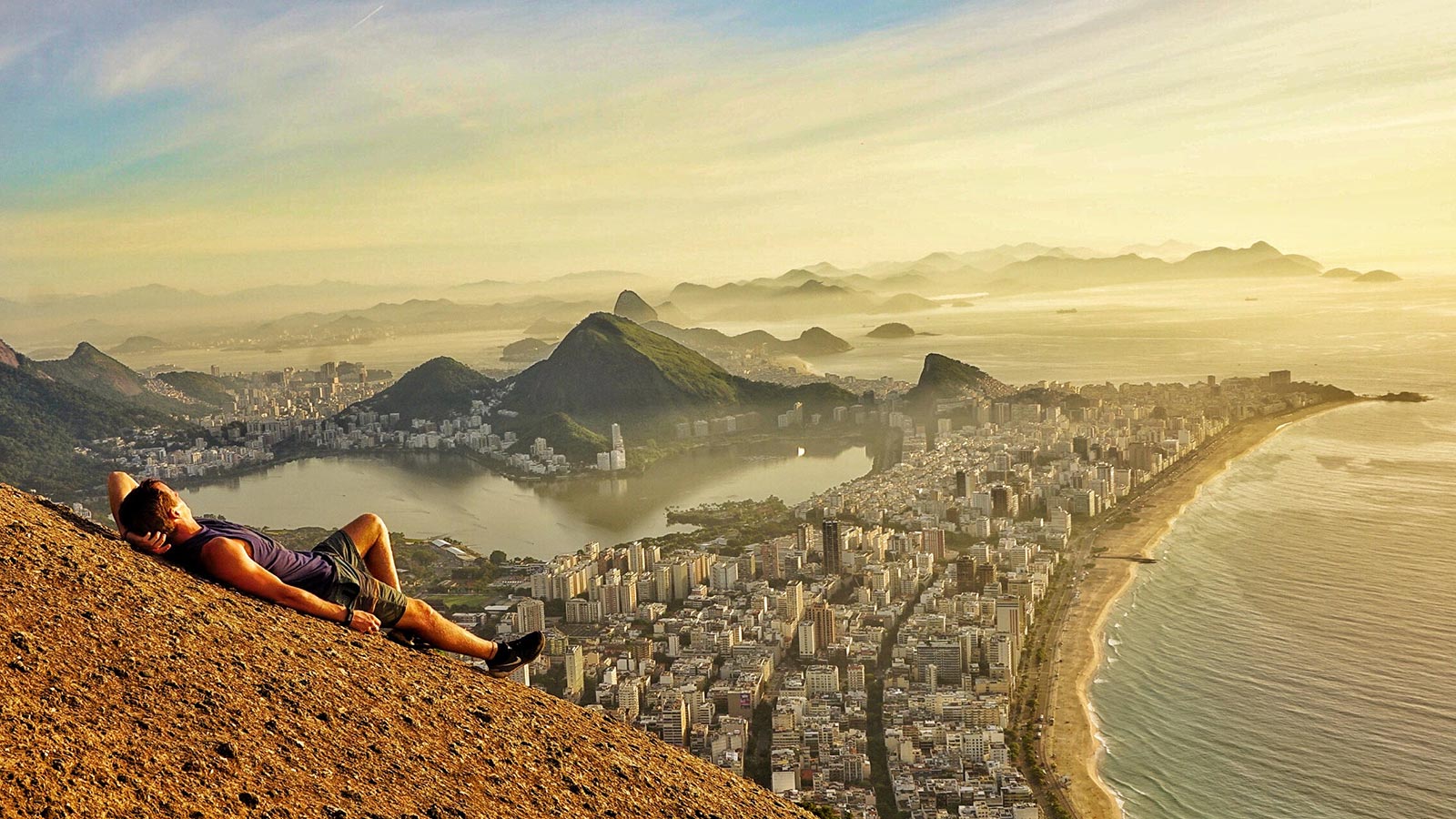 David Simpson lying down and enjoying the view at Two Brothers Peak in Rio de Janeiro, Brazil. Why am I starting a blog?