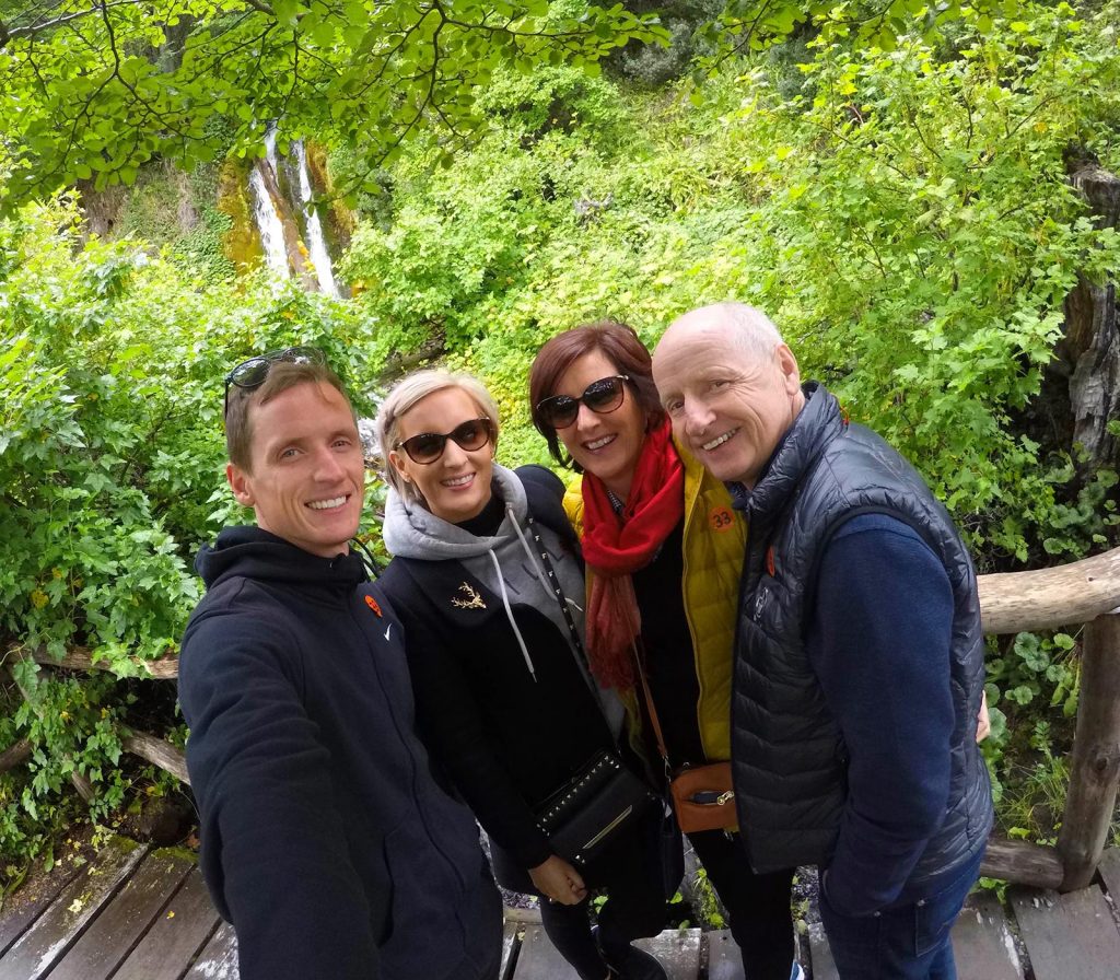 David Simpson and family by the trees and waterfall in Ushuaia, Argentina. Cape Horn on the Cruise to the end of the world