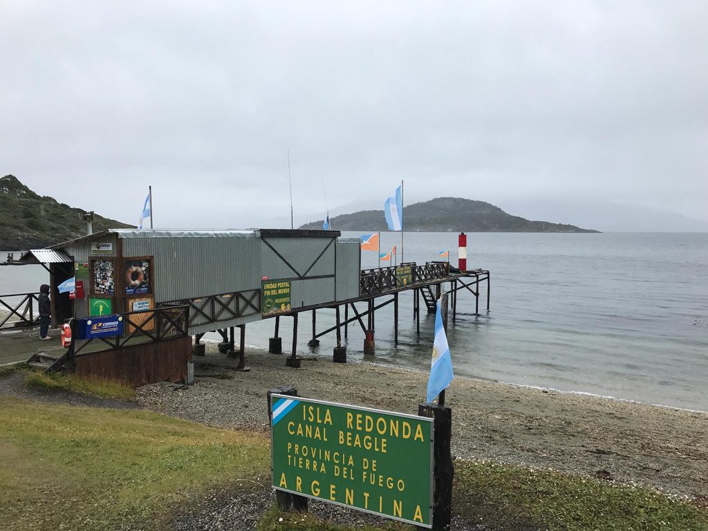 Dock with sign by the beach in Ushuaia, Argentina. Cape Horn on the Cruise to the end of the world