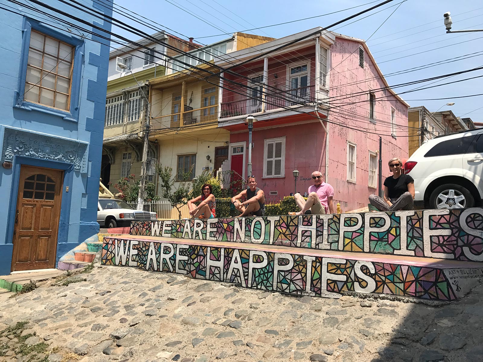 David Simpson and family sitting on a colorful steps in Valparaiso, Chile. Valparaiso & The Cruise to the end of the World pt3