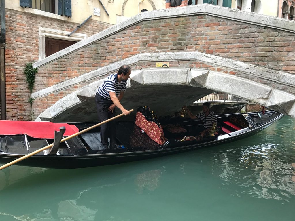 Gondola going under the bridge in Venice, Italy. Magical Venice