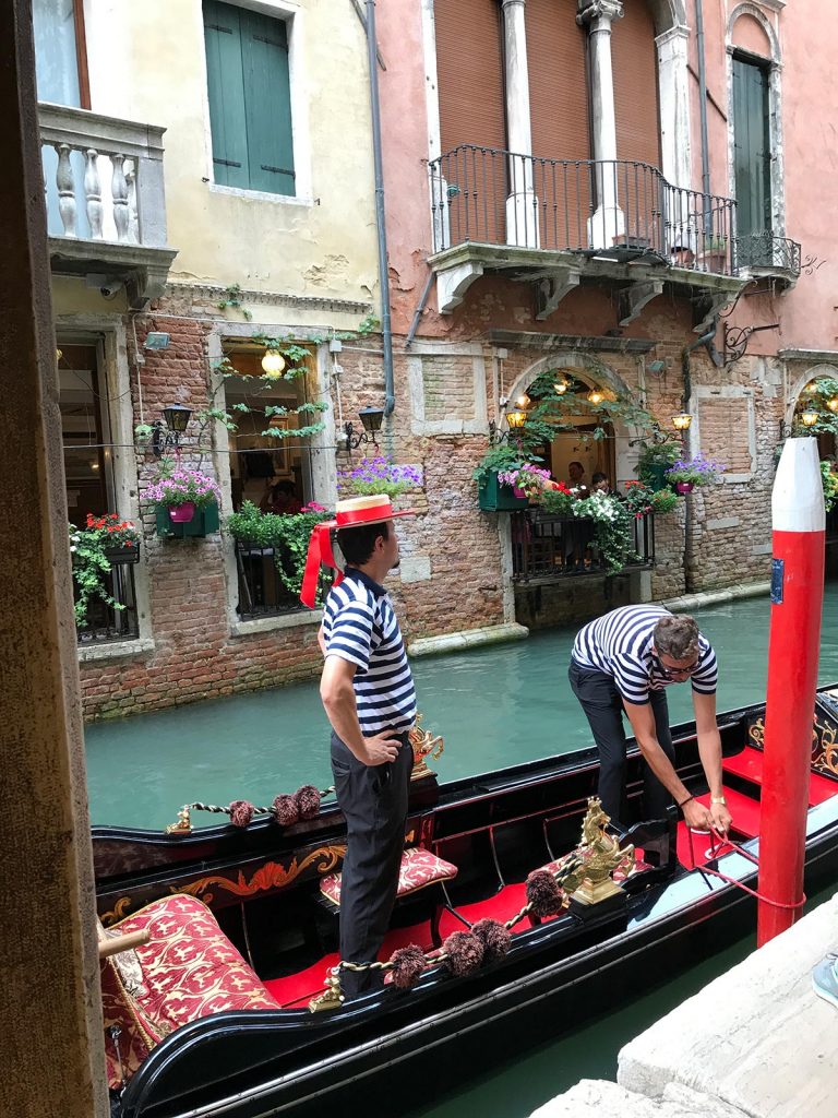 Gondoliers on gondola in Venice, Italy. Magical Venice