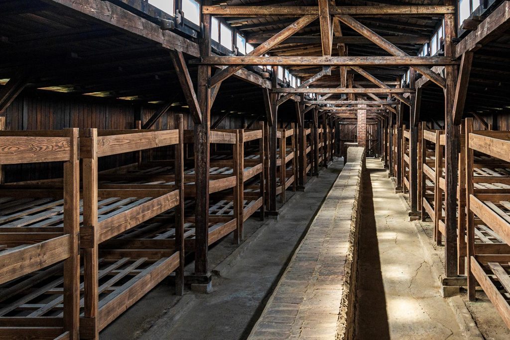 Beds inside wooden shed in Auschwitz, Oświęcim, Poland. Mixed feelings in Auschwitz