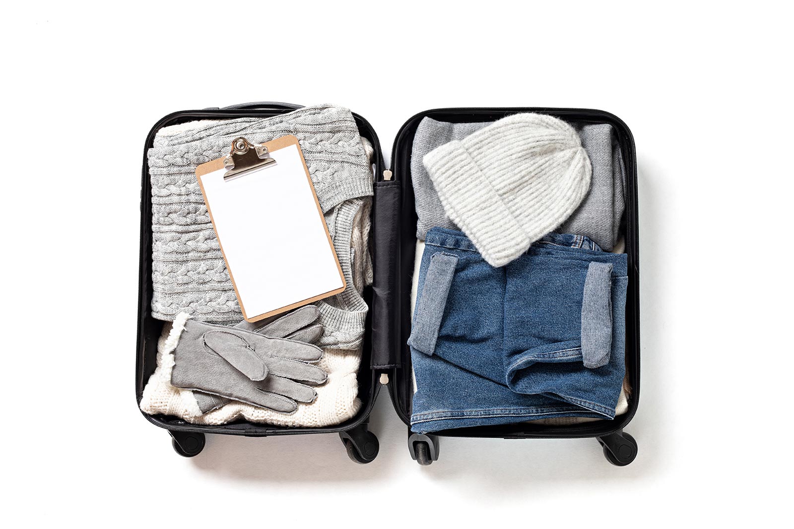 Packed suitcase for cold weather. Complete packing guide for the Faroe Islands