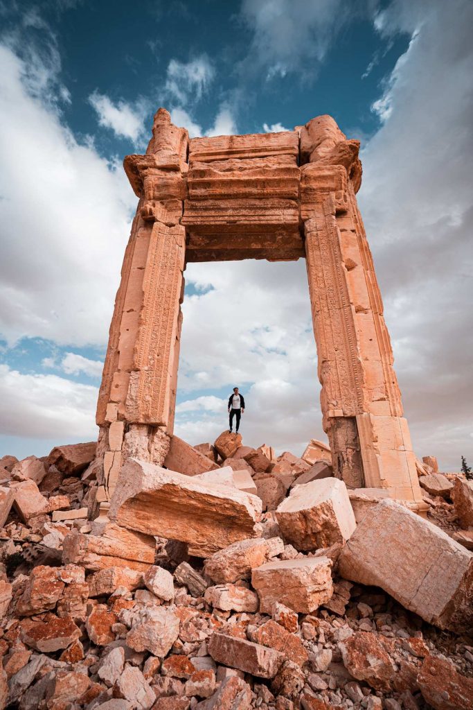 David Simpson standing at ruins in Palmyra, Syria. The ruined ruins of Palmyra