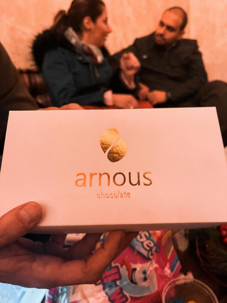 Local couple and box of Arnous chocolates in Palmyra, Syria. The ruined ruins of Palmyra