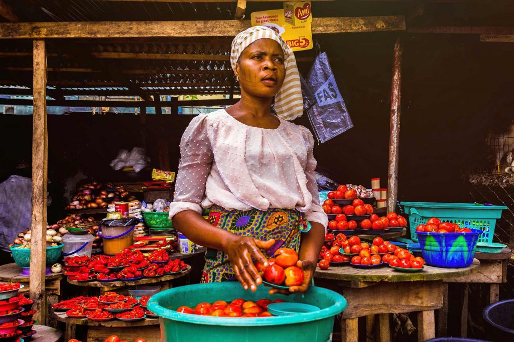 Local woman selling fruits in Africa. Plans for 2022